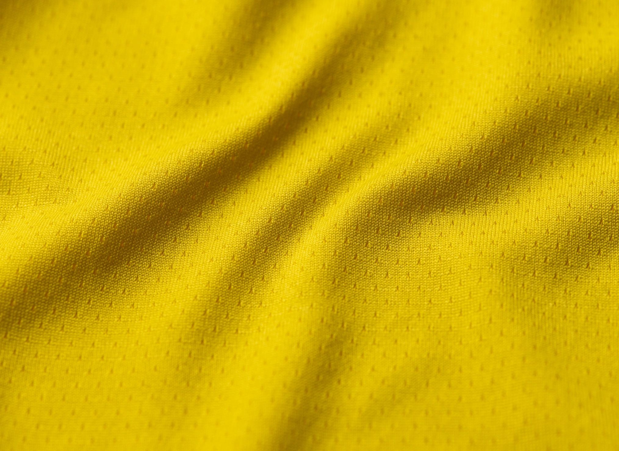 Close-up sports jersey fabric texture in yellow